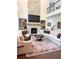 Bright living room features a stone fireplace, TV, built-ins, and two large sofas at 4736 Landing Water Path, Buford, GA 30519
