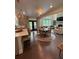 Open-concept living area with hardwood floors, fireplace, and large windows offering natural light at 4736 Landing Water Path, Buford, GA 30519