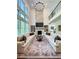 Spacious living room featuring a stone fireplace, built-in shelves, and large windows for natural light at 4736 Landing Water Path, Buford, GA 30519
