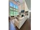 Bright and airy living room offers tall windows, a fireplace, and comfortable seating at 4736 Landing Water Path, Buford, GA 30519