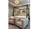 Well-appointed main bedroom featuring a canopy bed, seating area, and elegant décor, perfect for rest and rejuvenation at 4736 Landing Water Path, Buford, GA 30519