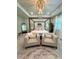 A spacious main bedroom features a decorative chandelier, sitting area, and a four-poster bed at 4736 Landing Water Path, Buford, GA 30519