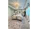 Serene main bedroom featuring a canopy bed, armchairs, and a decorative chandelier, designed for ultimate relaxation at 4736 Landing Water Path, Buford, GA 30519