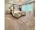 Spacious main bedroom with a canopy bed, sitting area, and neutral tones, creating a relaxing retreat at 4736 Landing Water Path, Buford, GA 30519