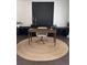 Well-lit office showcasing a jute rug, stylish desk, and herringbone accent wall, ideal for a productive work environment at 4736 Landing Water Path, Buford, GA 30519