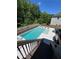 Luxurious backyard pool with hot tub, sun loungers, and a serene view of surrounding trees at 4736 Landing Water Path, Buford, GA 30519