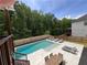 A beautiful in-ground pool is surrounded by lounge chairs and a dining table, perfect for outdoor entertaining at 4736 Landing Water Path, Buford, GA 30519