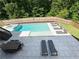 Resort-style pool with hot tub, surrounded by a spacious patio and lush greenery at 4736 Landing Water Path, Buford, GA 30519