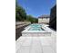 A sparkling in-ground pool and spa are surrounded by a patio, perfect for outdoor relaxation and entertaining at 4736 Landing Water Path, Buford, GA 30519