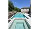 Backyard featuring a pristine in-ground pool and attached spa, ideal for a luxurious outdoor experience at 4736 Landing Water Path, Buford, GA 30519