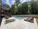 This backyard features a sparkling in-ground pool, with sun loungers and a dining area for outdoor relaxation at 4736 Landing Water Path, Buford, GA 30519