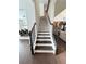 Staircase with dark wood steps, white risers, and black iron railing at 4736 Landing Water Path, Buford, GA 30519