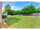 Spacious backyard with lush green grass, privacy fence, and mature trees at 1892 Ivy View Walk, Loganville, GA 30052