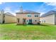 Home's backyard with a well-manicured lawn, patio area, and neighboring houses at 1892 Ivy View Walk, Loganville, GA 30052
