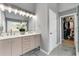 Elegant bathroom features a double vanity, large mirror, and a door that leads into the closet at 1892 Ivy View Walk, Loganville, GA 30052