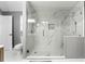Modern bathroom featuring a glass shower with dual showerheads and sleek marble tiling at 1892 Ivy View Walk, Loganville, GA 30052