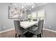Inviting dining area featuring a modern light fixture and an elegant table setting for six at 1892 Ivy View Walk, Loganville, GA 30052