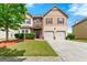 Inviting two-story home with a well-maintained lawn, two car garage, and appealing curb appeal at 1892 Ivy View Walk, Loganville, GA 30052