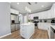 Well-lit kitchen featuring white cabinets, stainless steel appliances, and center island with breakfast bar at 1892 Ivy View Walk, Loganville, GA 30052