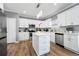 Modern kitchen featuring white cabinetry, stainless steel appliances, and a center island with marble countertops at 1892 Ivy View Walk, Loganville, GA 30052
