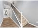 Elegant staircase featuring a white handrail, black metal spindles, and carpeted steps to the second story at 1892 Ivy View Walk, Loganville, GA 30052