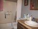 Bathroom with a tub/shower combo, vanity with sink, and essential toiletries at 2494 Bronco Trl, Duluth, GA 30096