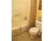 Well-lit bathroom featuring a toilet, bathtub with shower, tile floor, and a shower curtain at 2494 Bronco Trl, Duluth, GA 30096