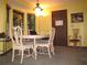 Dining room featuring a round wooden table with padded chairs, a laptop, and a cozy light fixture at 2494 Bronco Trl, Duluth, GA 30096