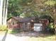 Charming single-story home featuring a garage, shingle siding, a red front door, and a well-maintained yard at 2494 Bronco Trl, Duluth, GA 30096