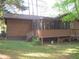Home's exterior showcasing a screened-in porch and wooden siding at 2494 Bronco Trl, Duluth, GA 30096