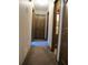 Hallway featuring paneled doors, neutral carpet and light walls that create a warm, inviting passage at 2494 Bronco Trl, Duluth, GA 30096