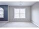 This bedroom features neutral colors and abundant natural light from two windows at 55 Little Barley Nw Ln, Grayson, GA 30017