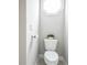 Bright powder room featuring a white toilet, octagonal window, and neutral wall color at 55 Little Barley Nw Ln, Grayson, GA 30017