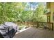 Outdoor deck surrounded by trees offering a peaceful retreat with ample space for seating and plants at 1105 Mitchell Crossing Sw Dr, Atlanta, GA 30331