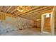 Unfinished basement with exposed ceiling, concrete wall, and stairs to the main floor at 33 Cedar Gate Ln, Kingston, GA 30145