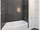 Bathroom showcasing a white tub with modern black tile at 33 Cedar Gate Ln, Kingston, GA 30145