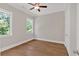 Bedroom features hardwood floors, two windows and a ceiling fan at 33 Cedar Gate Ln, Kingston, GA 30145