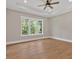 Bedroom with wood floors, neutral walls, and a tray ceiling providing natural light at 33 Cedar Gate Ln, Kingston, GA 30145