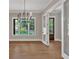 Bright dining area with hardwood floors, transom windows, and a modern chandelier for a warm ambiance at 33 Cedar Gate Ln, Kingston, GA 30145