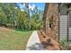 Stone and siding exterior with well maintained landscape featuring a sidewalk and a beautifully manicured lawn at 33 Cedar Gate Ln, Kingston, GA 30145