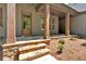 Inviting front porch with stone steps, wooden pillars, and a stained wood front door at 33 Cedar Gate Ln, Kingston, GA 30145