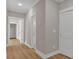 Bright hallway featuring hardwood floors, white trim, and doors leading to other rooms at 33 Cedar Gate Ln, Kingston, GA 30145