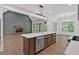 Open kitchen area featuring a large island, fireplace, and lots of natural light at 33 Cedar Gate Ln, Kingston, GA 30145