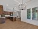 Open concept kitchen and dining area with wood floors and stylish lighting fixtures at 33 Cedar Gate Ln, Kingston, GA 30145