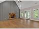 Bright living room with a vaulted ceiling, board and batten accent wall, and stone fireplace, perfect for relaxation at 33 Cedar Gate Ln, Kingston, GA 30145