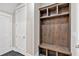 Mudroom with built-in storage cubbies and a bench on dark tile at 33 Cedar Gate Ln, Kingston, GA 30145
