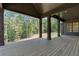 Spacious covered porch with beautiful views of the surrounding woods and access to the backyard at 33 Cedar Gate Ln, Kingston, GA 30145