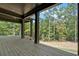 View of the outdoor porch area with wood railings and view of lush greenery and blue skies at 33 Cedar Gate Ln, Kingston, GA 30145