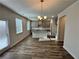Open-concept kitchen with modern pendant lighting, gray cabinets, stainless appliances, and wood flooring at 3964 Riverchess Lot#157 Sw Dr, Atlanta, GA 30331