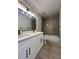 Modern bathroom featuring double sink vanity and a combined tub and shower behind a neutral tile at 655 Wellingborough Ct, Alpharetta, GA 30005
